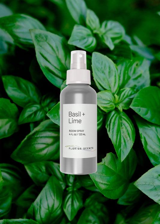 Basil + Lime Room Spray by Florida Scents Essentials placed over fresh basil leaves. Ideal for focus with a zesty, refreshing aroma.