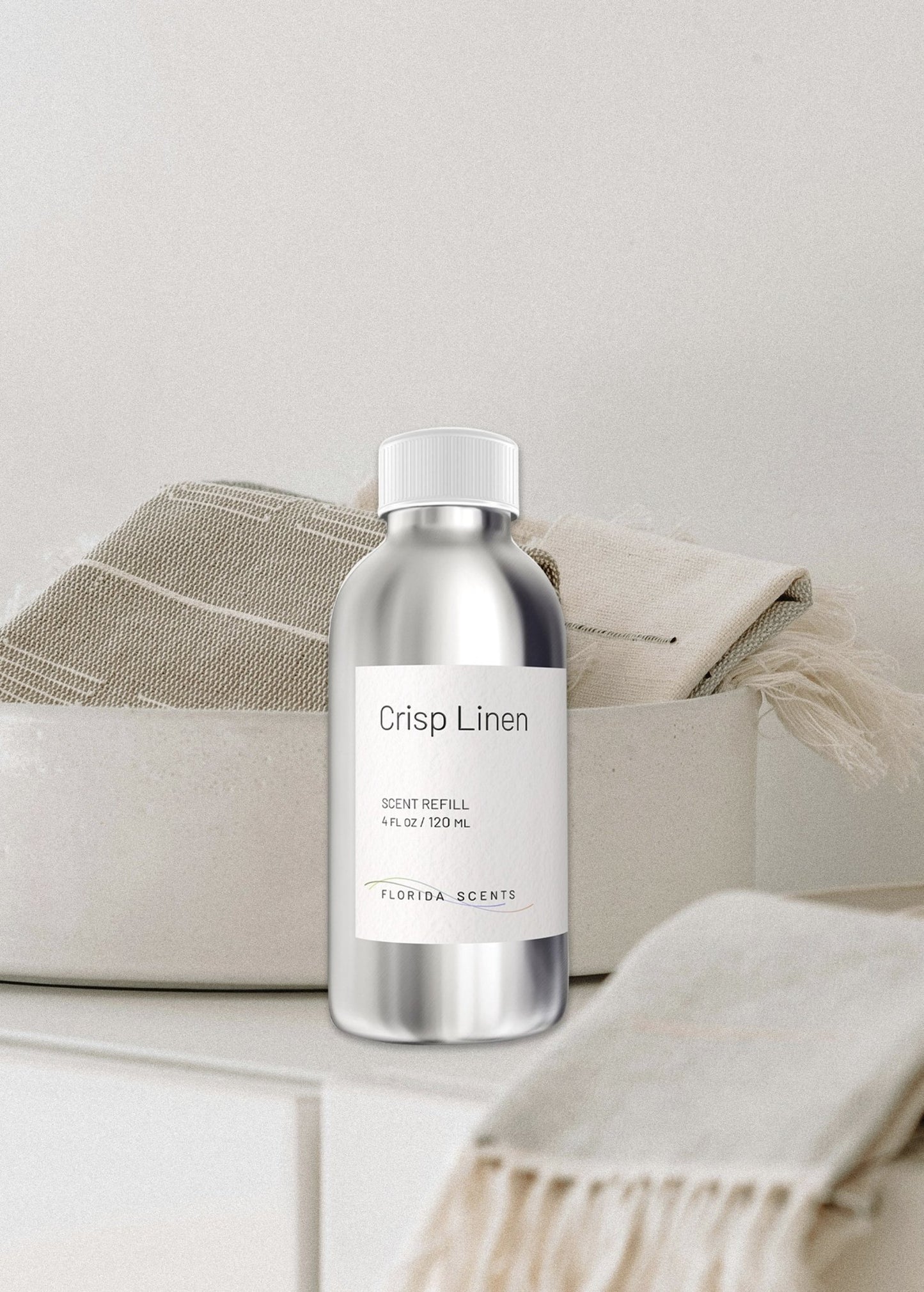 Florida Scents Essentials Crisp Linen Scent Refill bottle displayed beside folded towels, perfect for adding a fresh, clean aroma to home textiles.