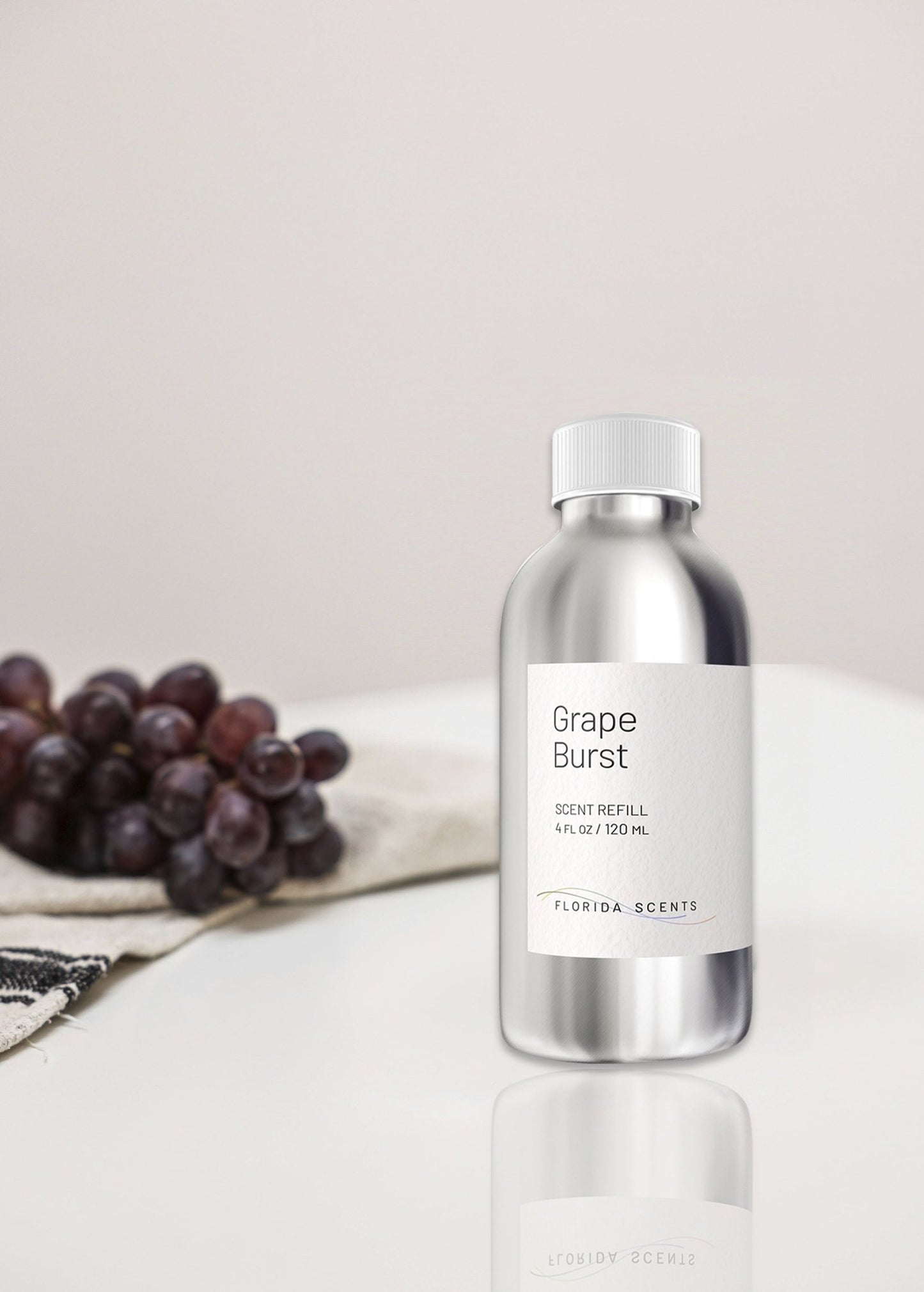 Grape Burst Scent Refill - Florida Scents Essentials shown with fresh grapes on a towel, perfect for sweet and tarty home fragrance ambiance.