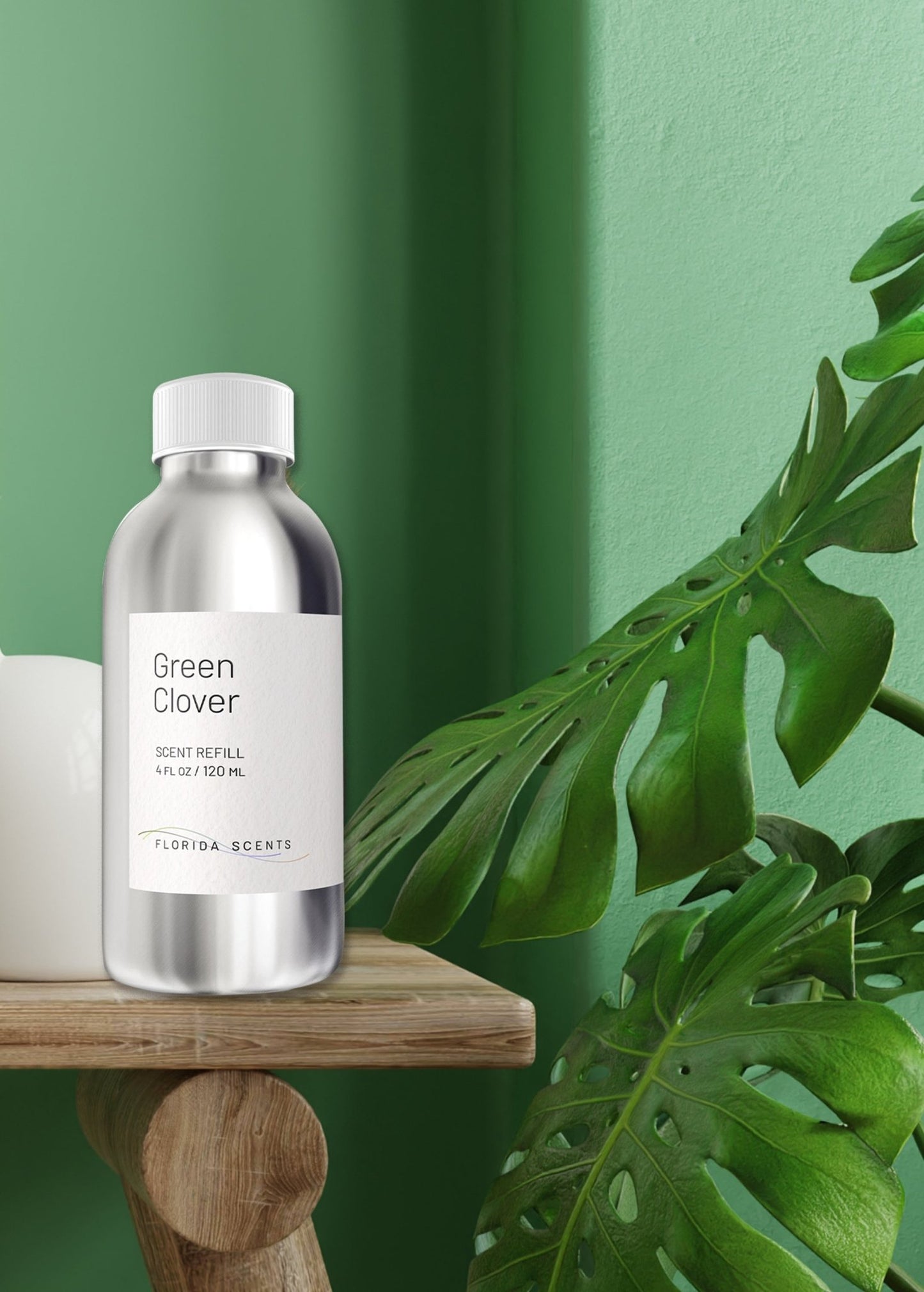 Green Clover Scent Refill - Florida Scents Essentials on wooden shelf with green wall and monstera leaf, perfect for refreshing indoor spaces naturally.