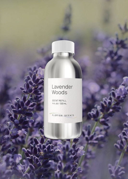 Lavender Woods Scent Refill by Florida Scents Essentials in a silver bottle, set against blooming lavender flowers. Ideal for stress relief at home.