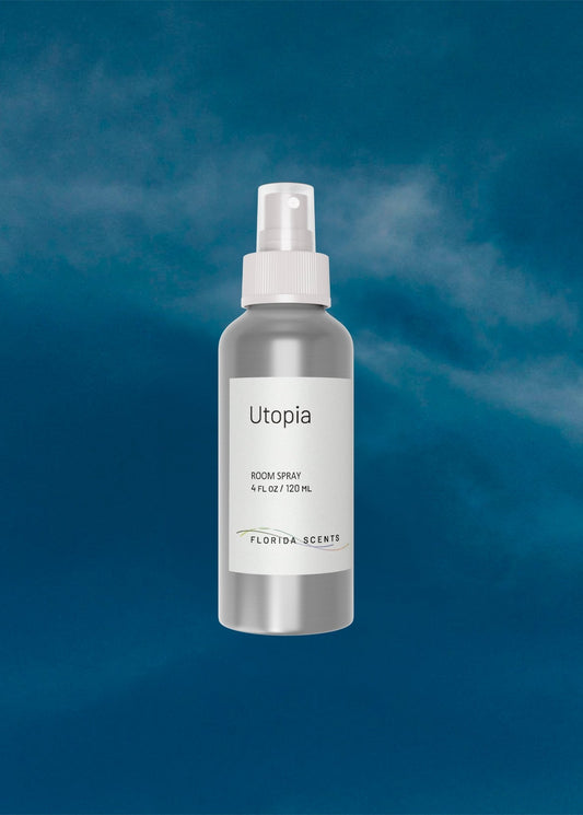 Utopia Room Spray by Florida Scents Essentials in a sleek silver bottle, ideal for enhancing home ambiance with citrus and earthy fragrance notes.