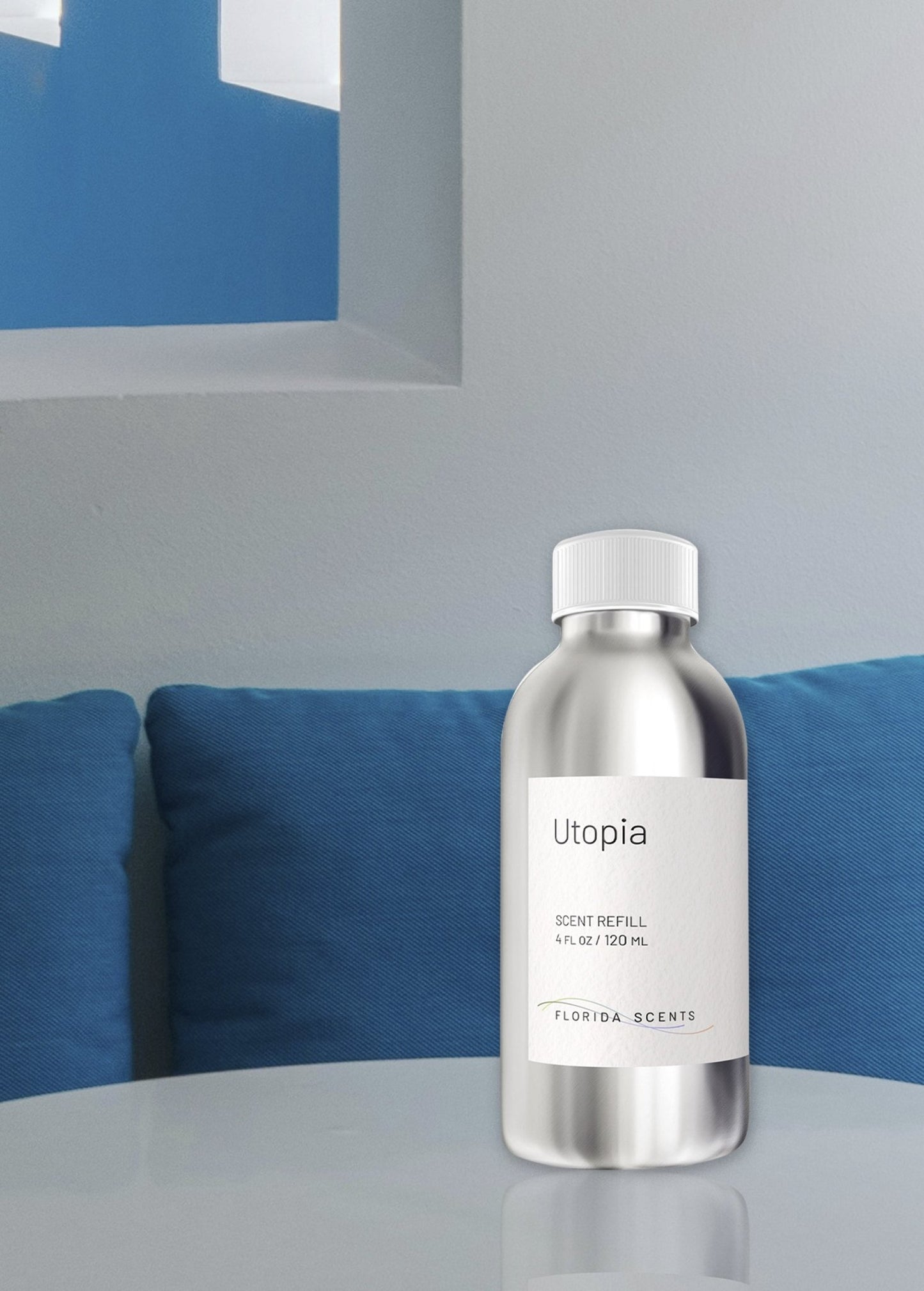 Utopia Scent Refill - Florida Scents Essentials placed on a modern table with blue cushions, perfect for enhancing serene home environments.