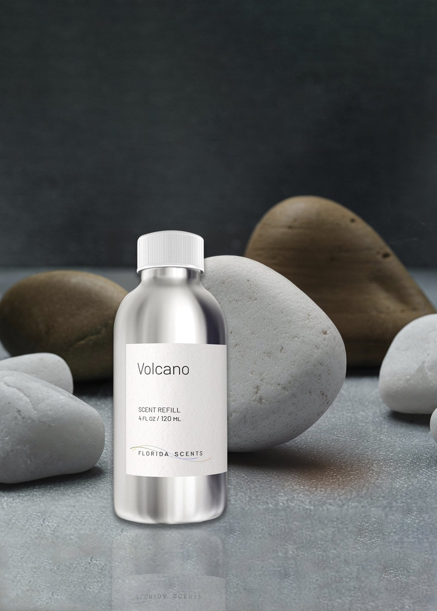 Volcano Scent Refill - Florida Scents Essentials 4 oz bottle placed among smooth stones, perfect for enhancing tropical and exotic home fragrance decor.